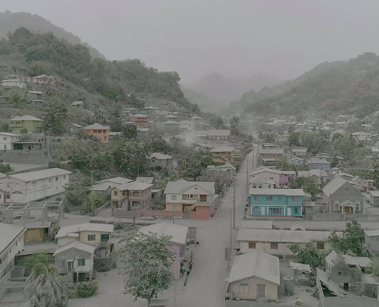 The landscape of St. Vincent and the Grenadines is shrouded in ash from the eruptions of the La Soufrière volcano in April 2021, which forced some 16,000 residents to evacuate their homes to cruise ships and safer parts of the island. © Stv Online